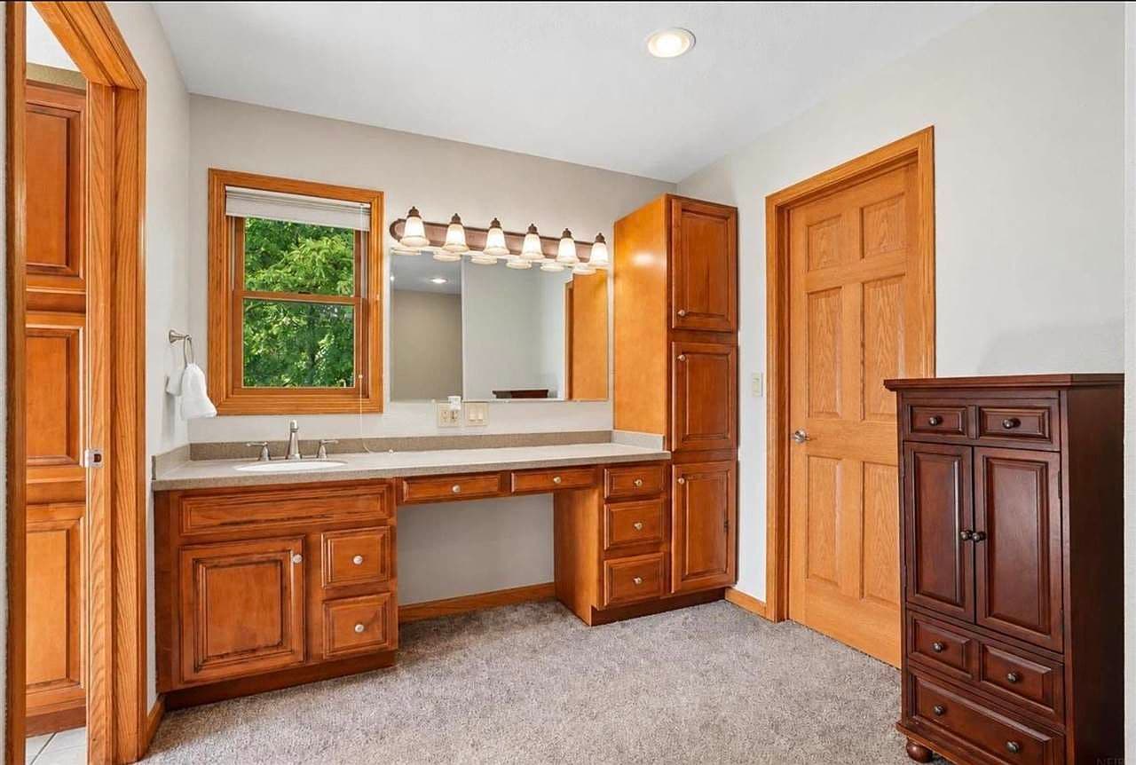 Dedicated dressing area with built-ins and bright natural light.