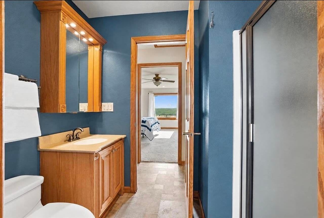 Walk-in shower and vanity with crisp coastal color.