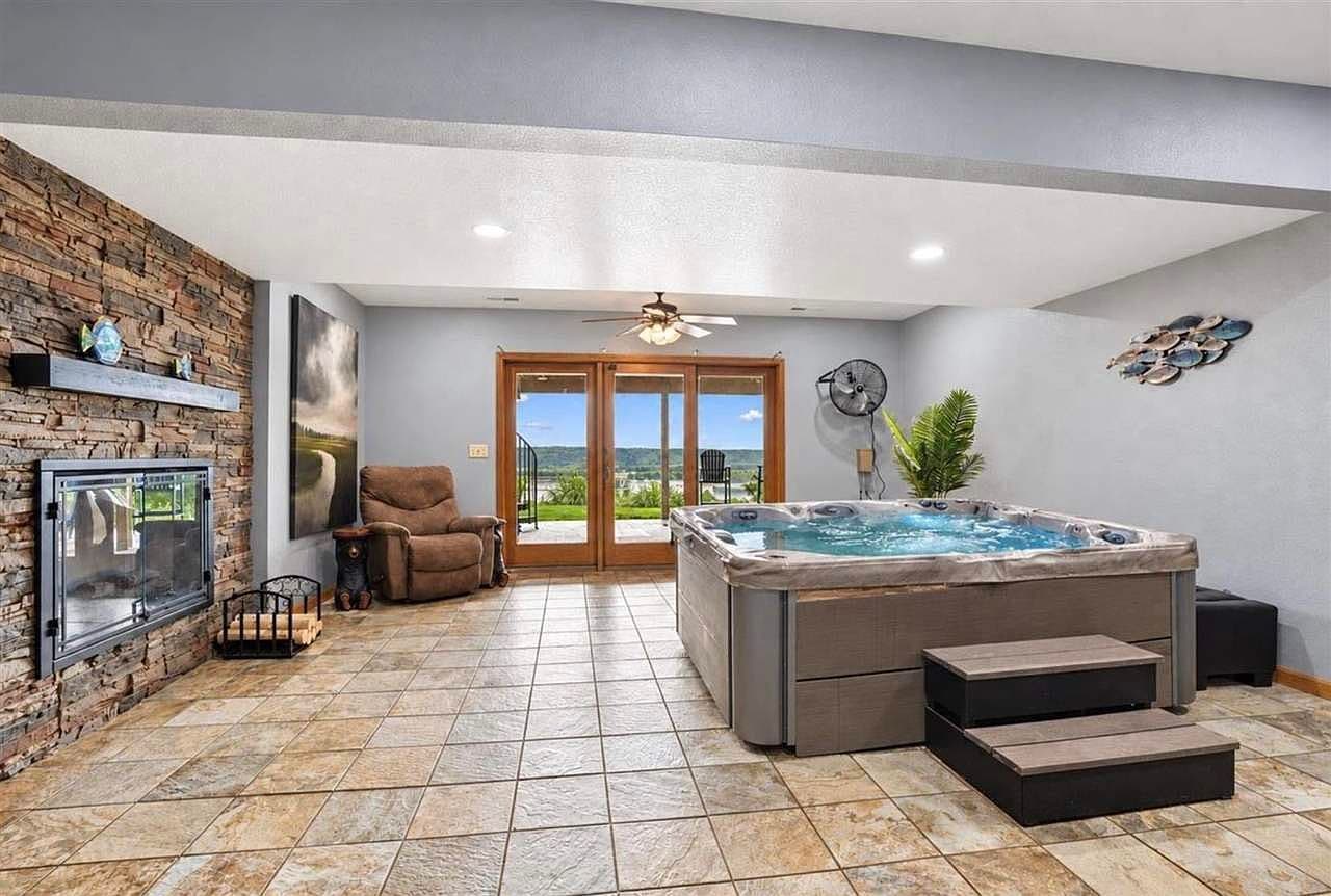 Lower-level retreat with gas fireplace and hot tub access.