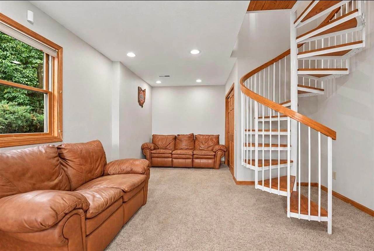 Cozy lower-level lounge with striking spiral staircase.