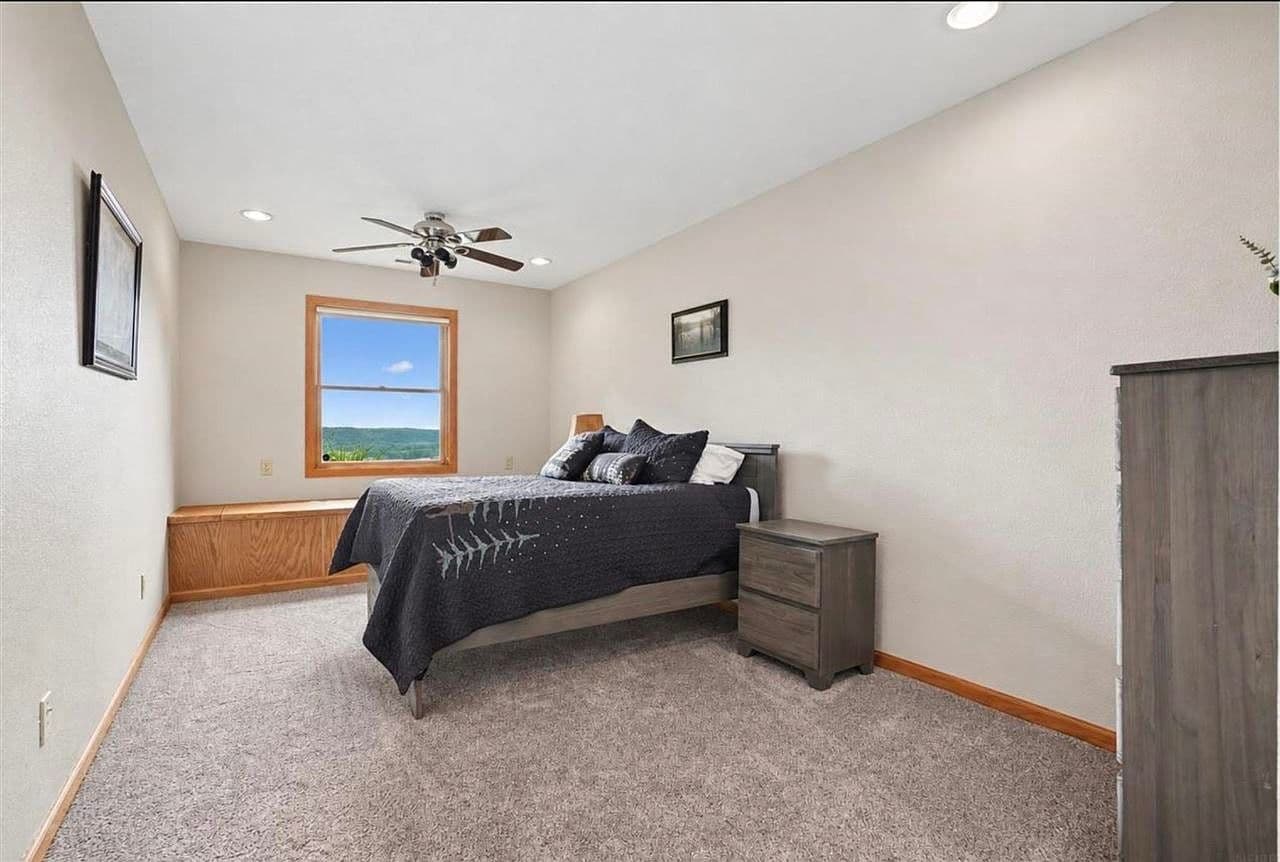 Lower-level bedroom featuring scenic bluff and river views.