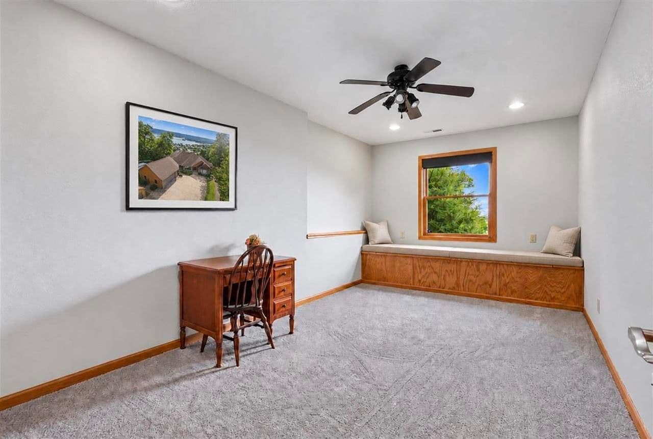 Bright bedroom with window-seat nook for reading.