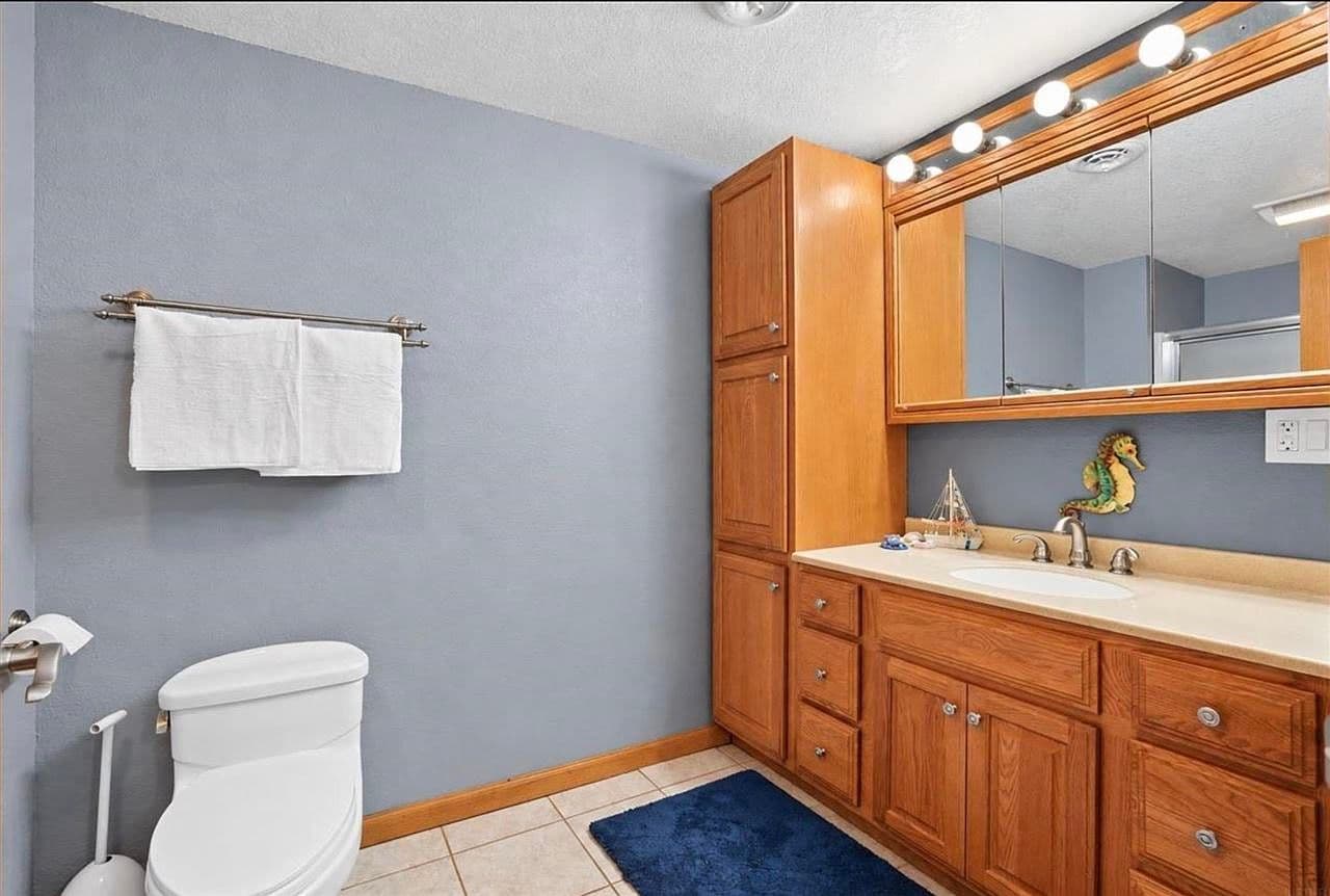 Classic vanity bath with ample storage and bright lighting.