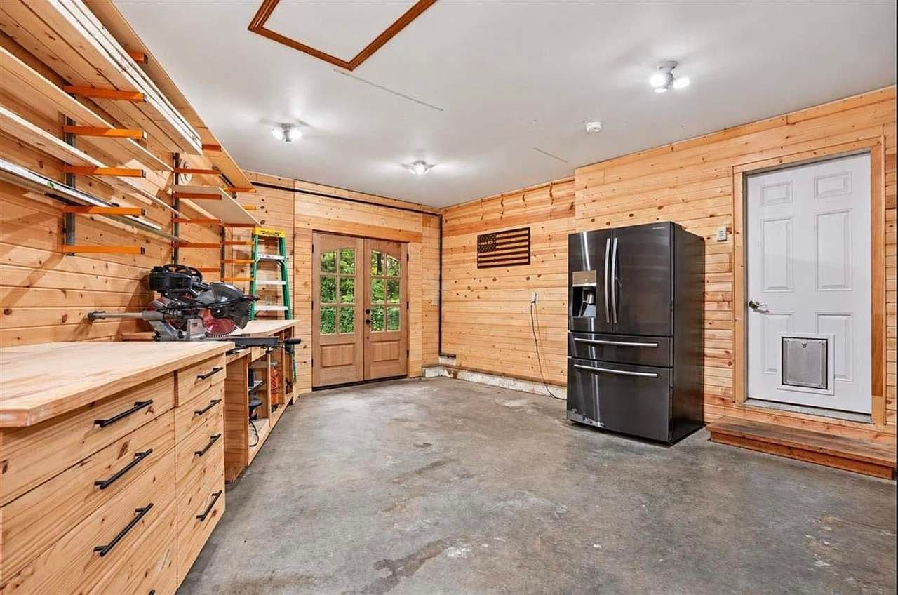 Oversized workshop/garage with built-ins and extra refrigerator.