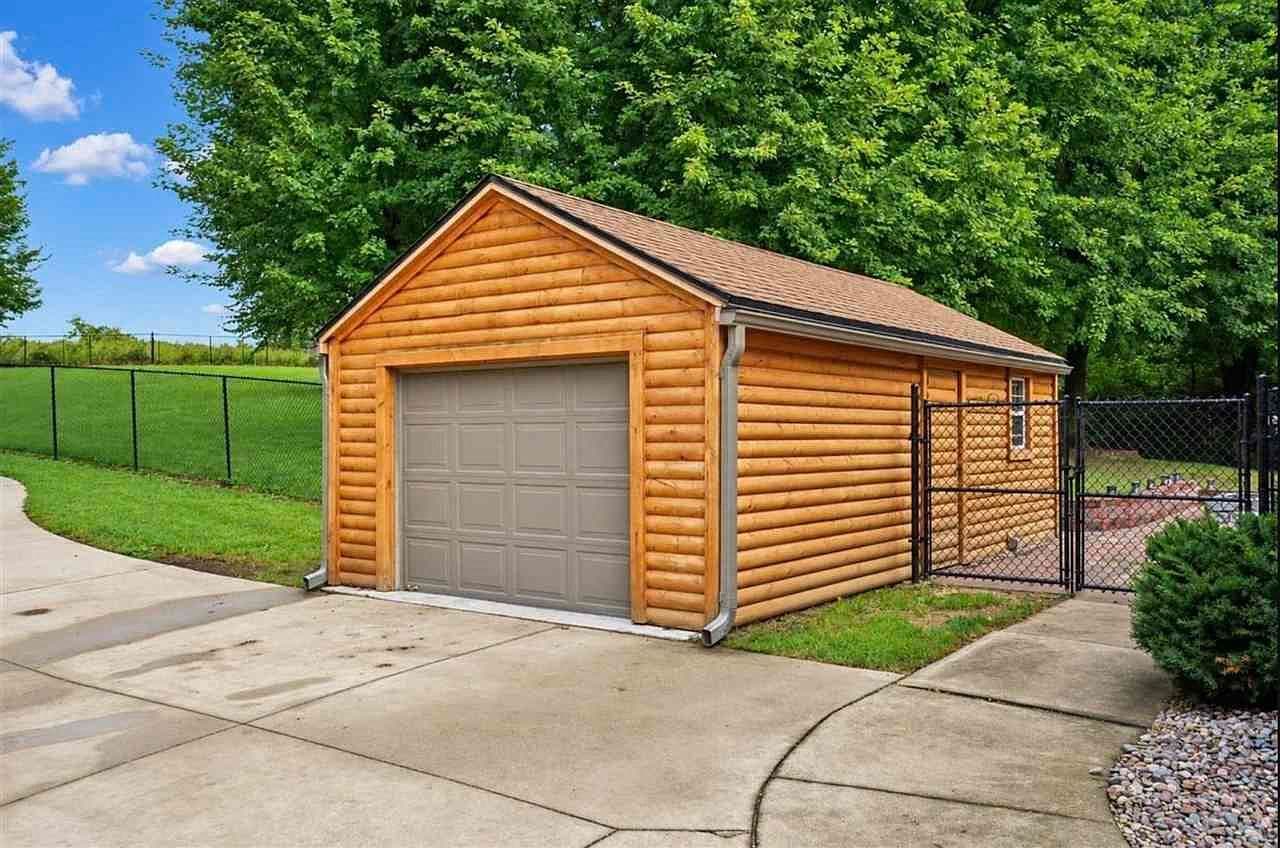 Detached log-style garage for toys, tools, and storage.