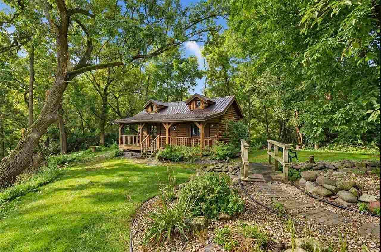 Secluded Amish-built log cabin retreat nestled in trees.
