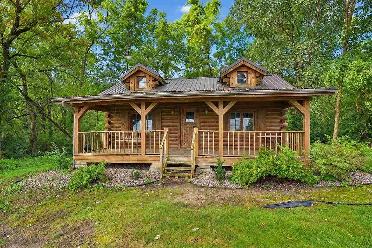 Charming log cabin with covered porch and lofted charm.