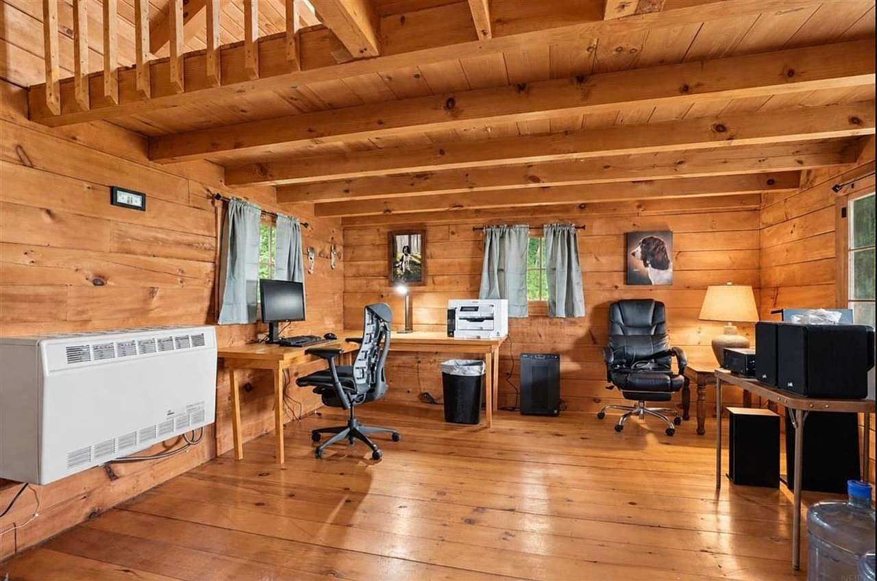 Rustic log-cabin office with warm wood interiors.