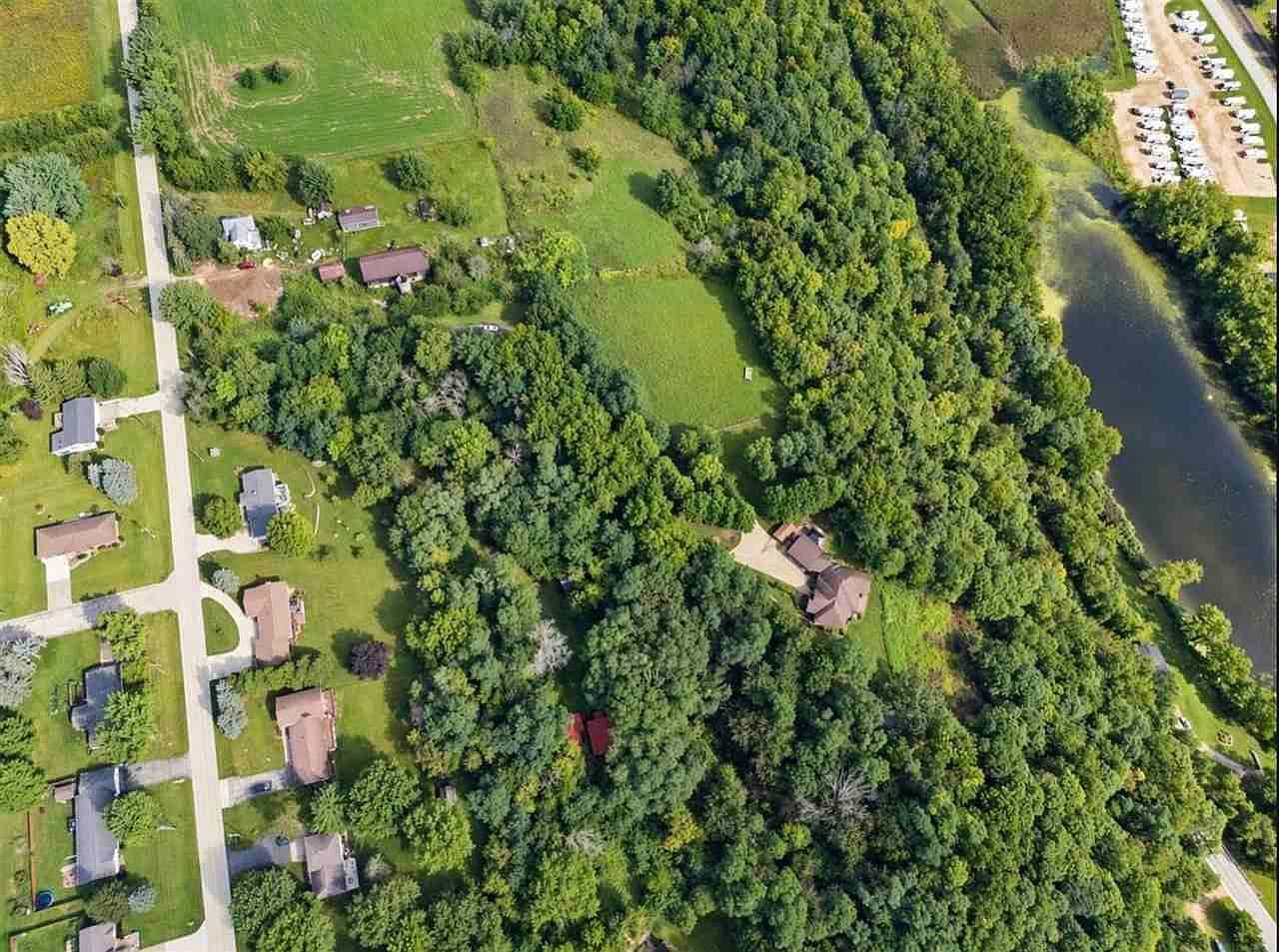 Aerial view of private retreat near river and town.