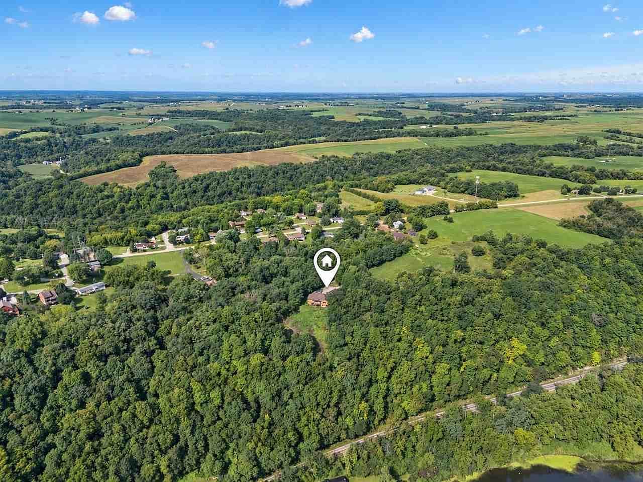 Panoramic countryside setting with forested privacy.