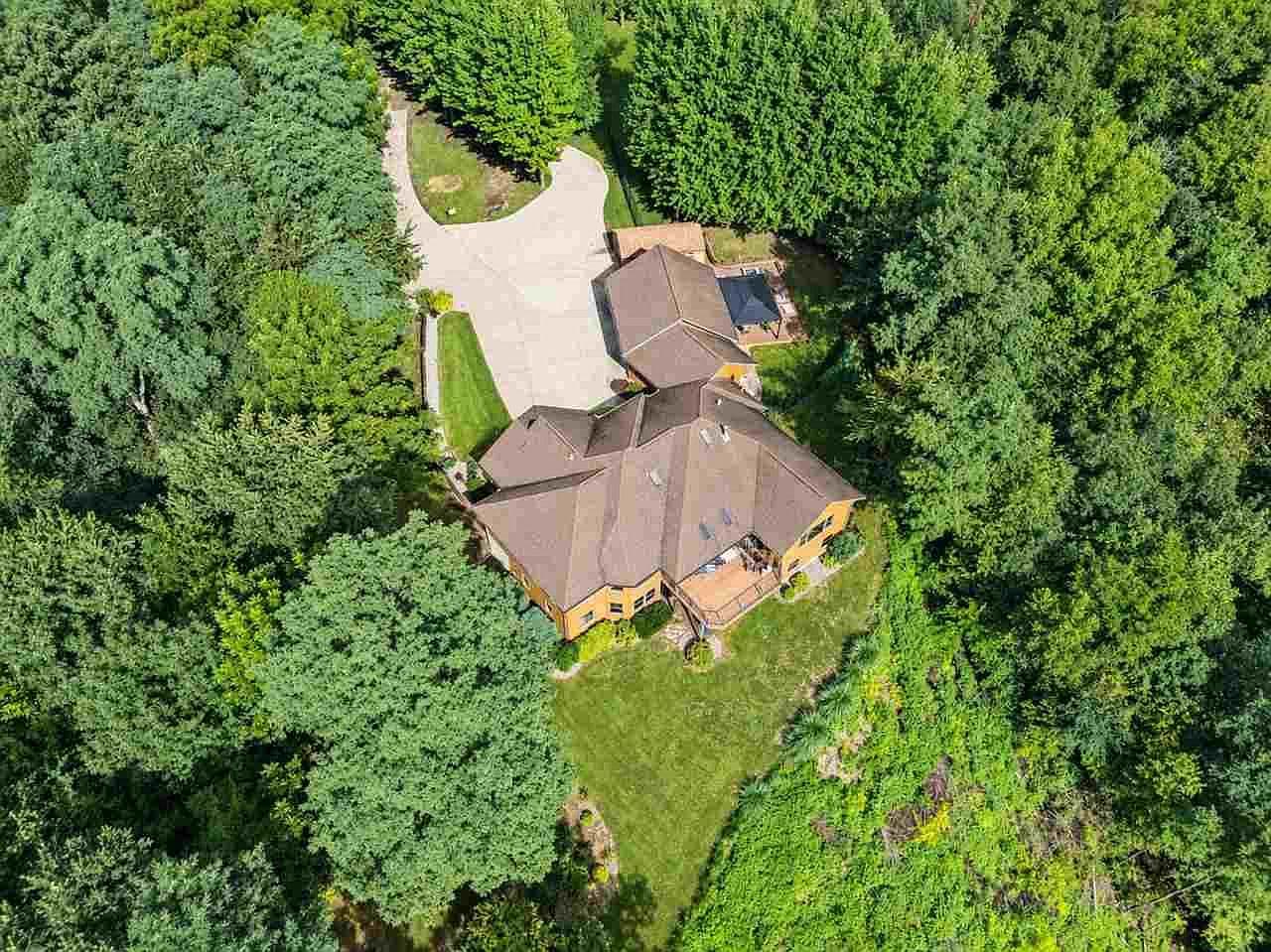 Bird’s-eye view of home and oversized driveway.